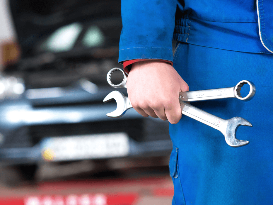 Hand of car mechanic with wrench